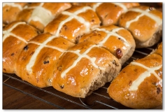 Homemade fresh from the oven hot cross buns on cooling rack